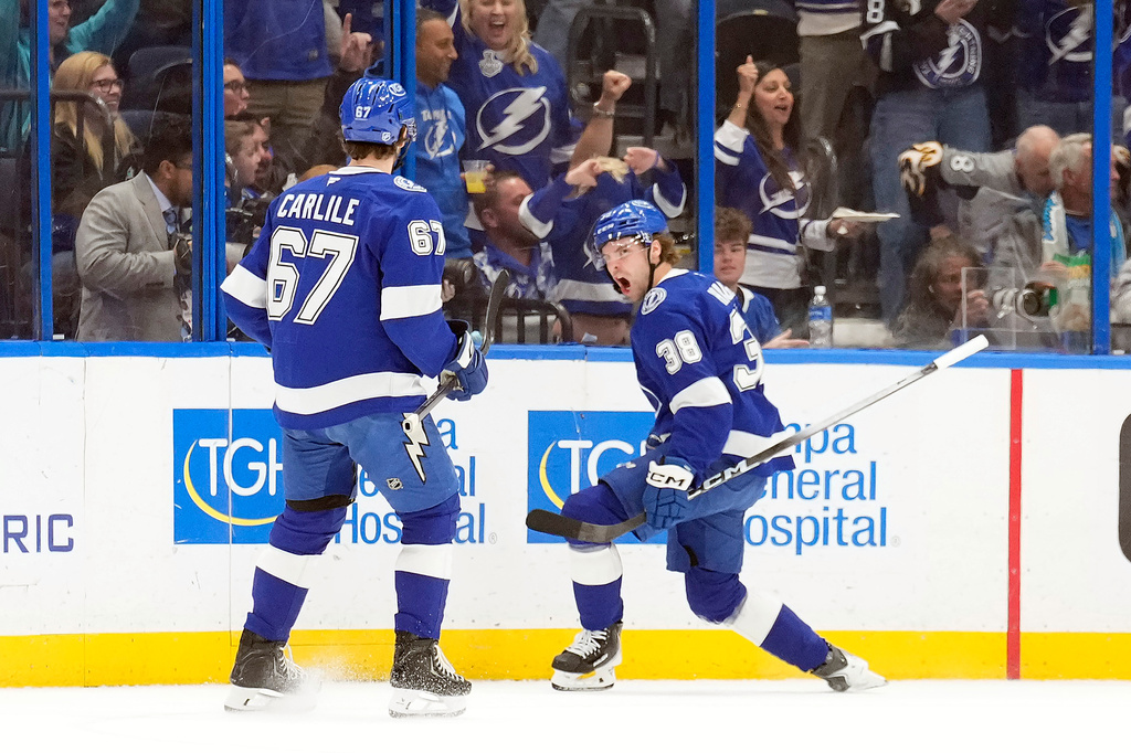 Tampa Bay Lightning left wing Brandon Hagel (38) celebrates his goal against the San Jose Sharks with defenseman Declan Carlile (67) during the first period of an NHL hockey game Tuesday, Jan. 20, 2026, in Tampa, Fla. (AP Photo/Chris O'Meara)