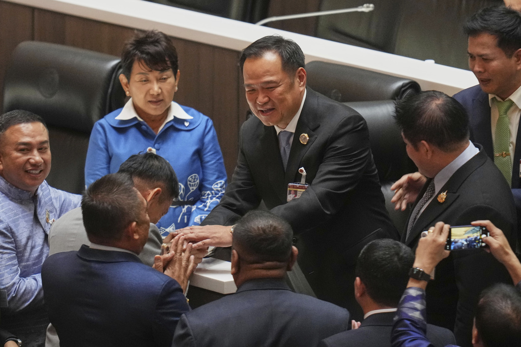 FILE- Leader of Bhumjai Thai Party Anutin Charnvirakul, center, reacts after lawmakers voted to select him as new prime minister, at the Parliament in Bangkok, Thailand, Friday, Sept. 5, 2025. (AP Photo/Sakchai Lalit, File)