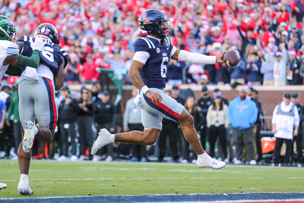 Mississippi quarterback Trinidad Chambliss (6) scores a touchdown against Tulane during the first round of the NCAA College Football Playoff, Saturday, Dec. 20, 2025, in Oxford, Miss. (AP Photo/James Pugh)