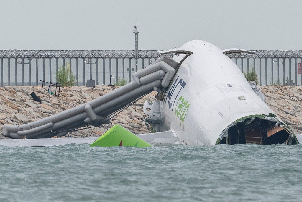 A view of the cargo aircraft that skidded off a Hong Kong runway on Monday, Oct. 20, 2025. (AP Photo/Chan Long Hei)