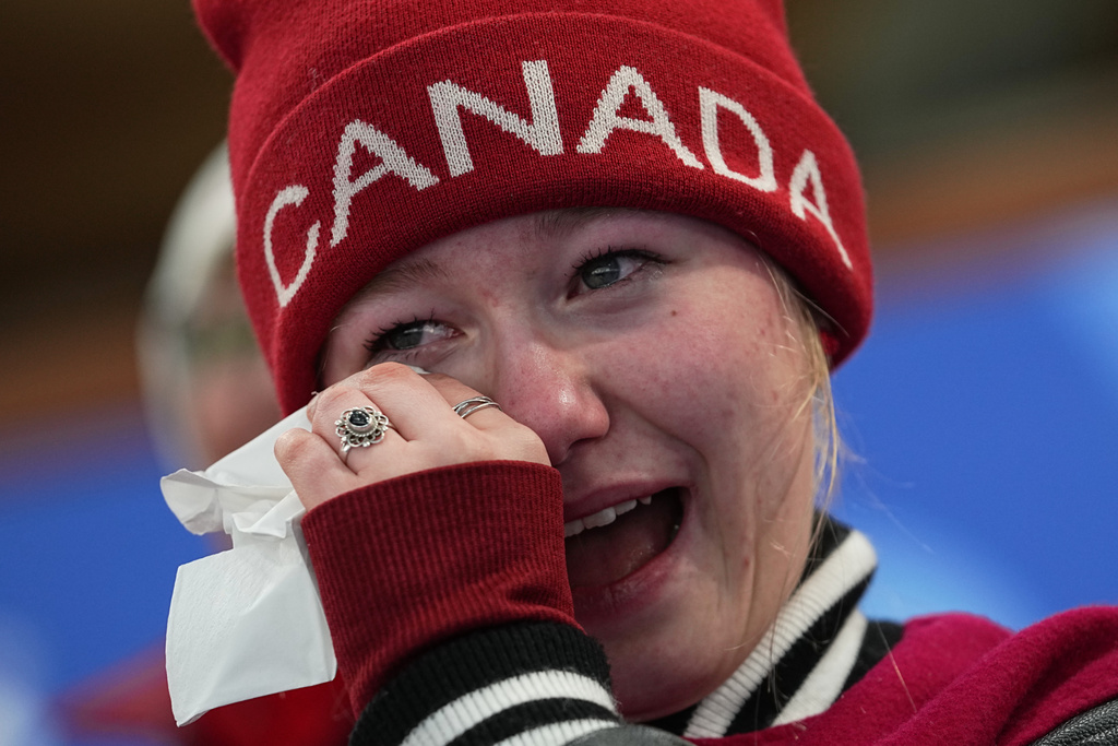 A fan of Canada reacts after Canada defeated Norway in a men's curling semifinal match at the 2026 Winter Olympics, in Cortina d'Ampezzo, Italy, Thursday, Feb. 19, 2026. (AP Photo/Fatima Shbair)