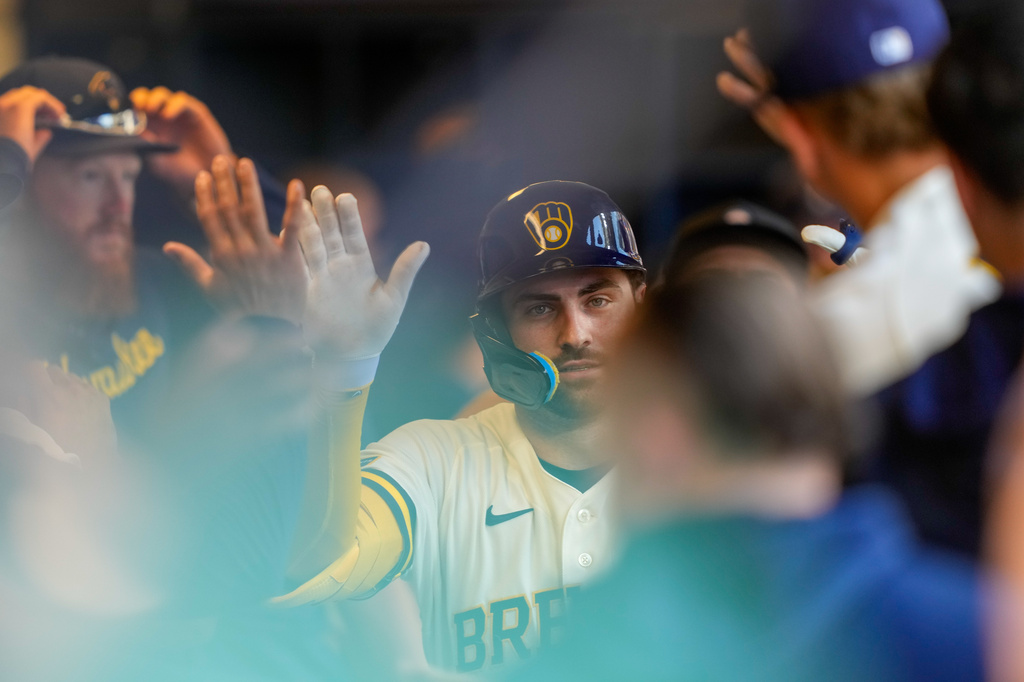 Milwaukee Brewers' Garrett Mitchell high-fives teammates after hitting a home run during the eighth inning of a baseball game against the Seattle Mariners Thursday, Aug. 20, 2026, in Milwaukee. (AP Photo/Kayla Wolf)