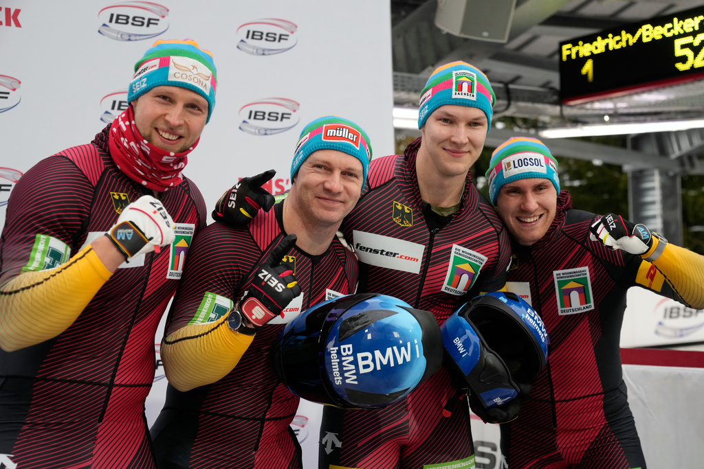 Francesco Friedrich, Tim Becker, Alexander Schueller and Felix Straub, of Germany, pose after winning the 4-man bobsleigh race at the Bobsleigh World Cup in Innsbruck, Austria, Sunday, Nov. 30, 2025. (AP Photo/Matthias Schrader)
