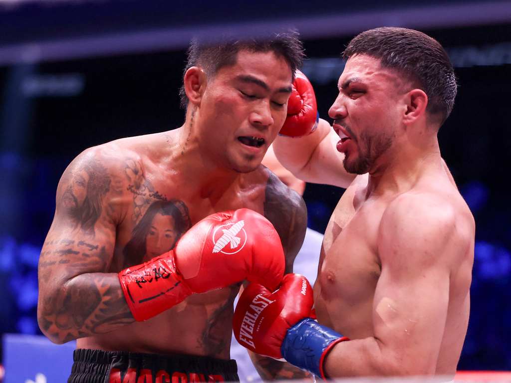 Andres Cortes, right, punches Mark Magsayo in their lightweight fight Saturday, Sept. 12, 2026, in Las Vegas. (AP Photo/Ian Maule)
