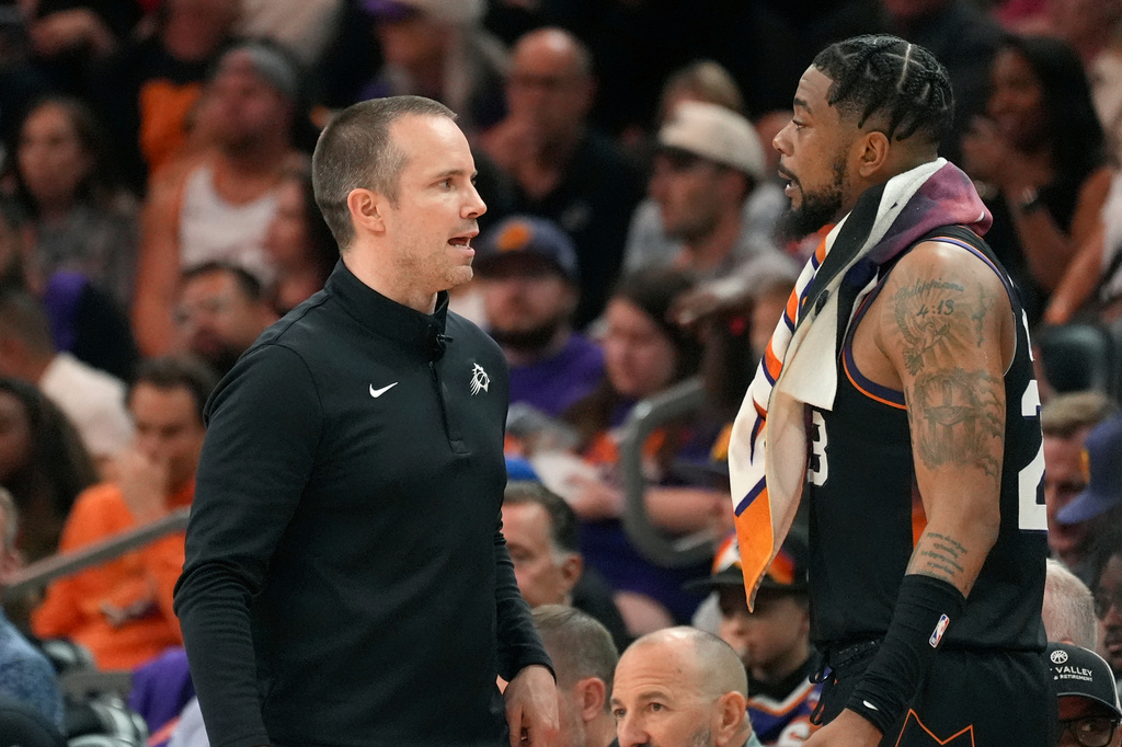 Phoenix Suns head coach Jordan Ott, left, talks with Suns guard Jordan Goodwin during the second half of an NBA play-in tournament basketball game against the Portland Trail Blazers, Tuesday, April 14, 2026, in Phoenix. (AP Photo/Ross D. Franklin)