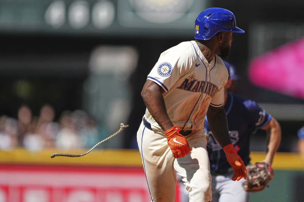 Seattle Mariners' Randy Arozarena loses his chain as he is caught trying to steal second base by Tampa Bay Rays second baseman Brandon Lowe during the sixth inning of a baseball game Sunday, Aug. 10, 2025, in Seattle. (AP Photo/Lindsey Wasson)