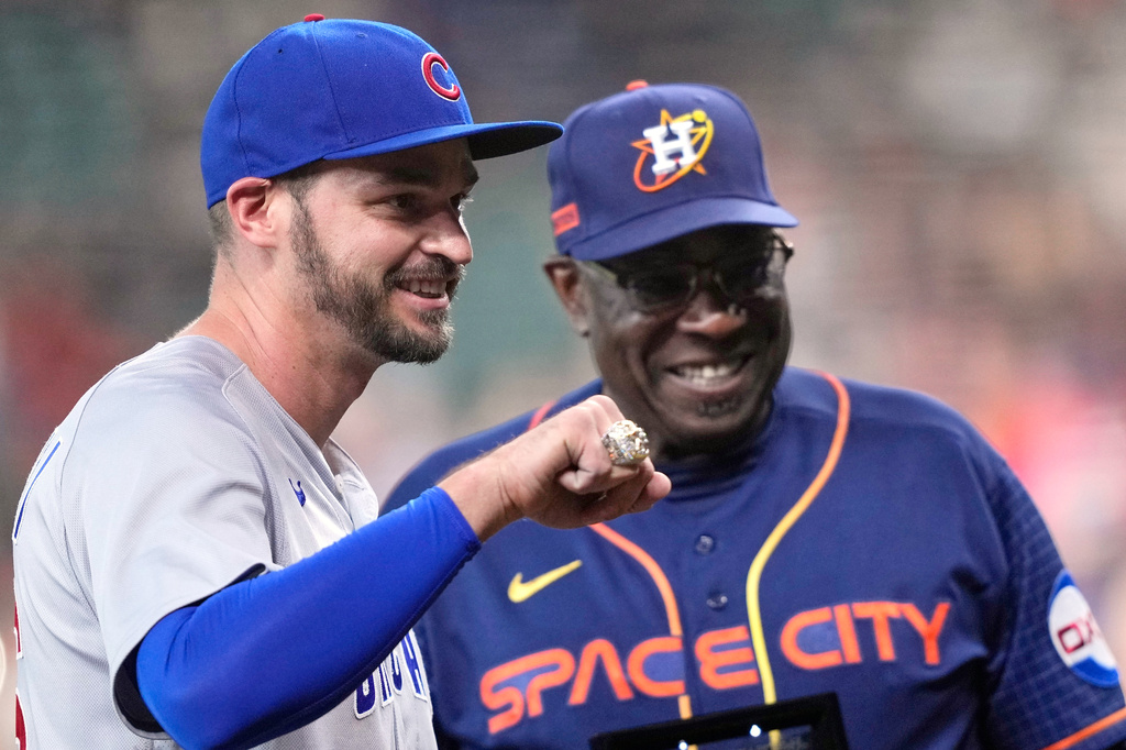 FILE - Chicago Cubs first baseman Trey Mancini, left, holds up his World Series Championship ring after it was presented to him by Houston Astros manager Dusty Baker Jr., before a baseball game, May 15, 2023, in Houston. (AP Photo/David J. Phillip, File)