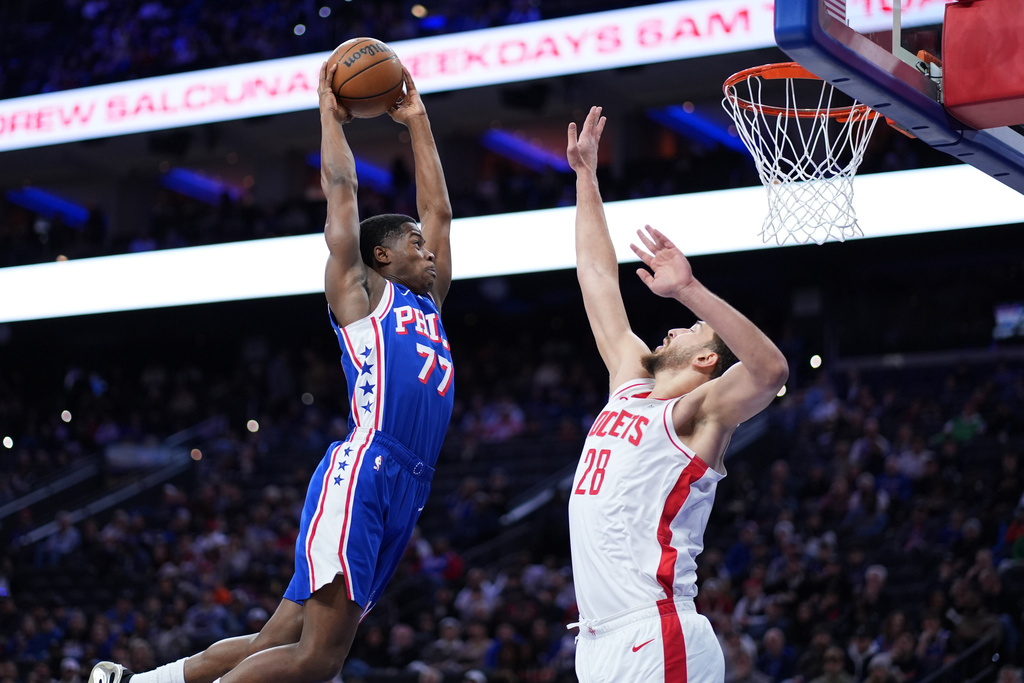 Philadelphia 76ers' VJ Edgecombe, left, goes up for a dunk against Houston Rockets' Alperen Sengun during the first half of an NBA basketball game Thursday, Jan. 22, 2026, in Philadelphia. (AP Photo/Matt Slocum)