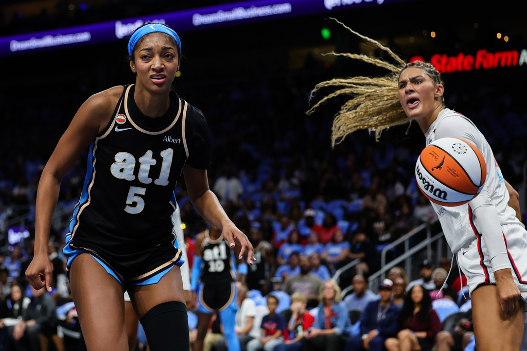 Atlanta Dream forward Angel Reese (5) and Washington Mystics center Lauren Betts, right, react during the first half in Game 1 of an WNBA basketball first-round playoff series, Sunday, Sept. 27, 2026, in Atlanta. (AP Photo/Colin Hubbard)