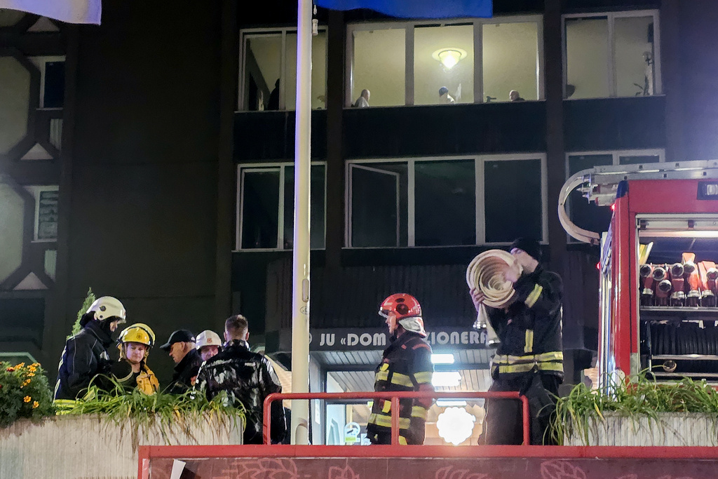 Firefighters stand guard in front of a nursing home after a fire in Tuzla, Bosnia, Tuesday, Nov. 4, 2025. (AP Photo)