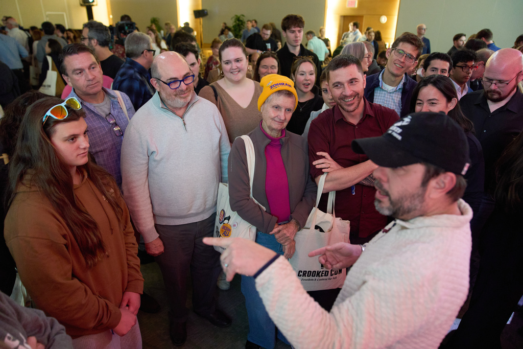 Sen. Ruben Gallego, D- Ariz., front, is greeted by attendees of Crooked Con after he spoke, Friday, Nov. 7, 2025, in Washington. (AP Photo/Jacquelyn Martin)