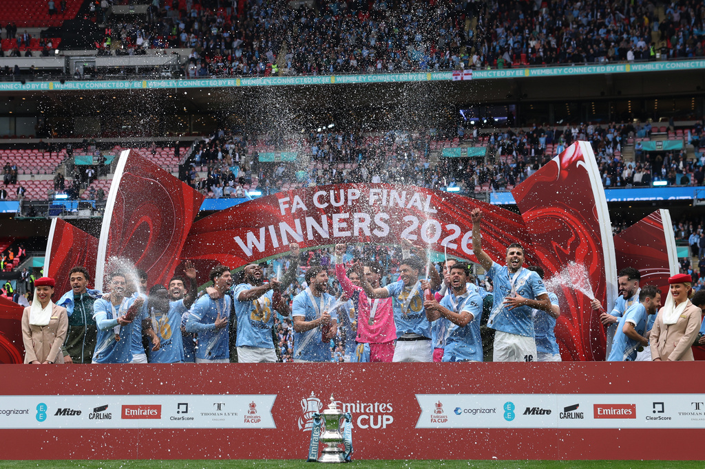 Manchester City players celebrate with the winner's trophy after the English FA Cup final soccer match between Chelsea and Manchester City in London, Saturday, May 16, 2026. (AP Photo/Richard Pelham)