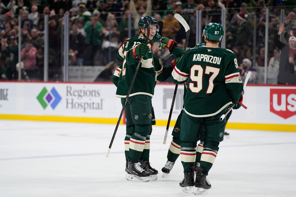 Minnesota Wild left wing Matt Boldy (12) celebrates toward left wing Kirill Kaprizov (97) after scoring a goal during the first period of an NHL hockey game against the Edmonton Oilers, Saturday, Dec. 20, 2025, in St. Paul, Minn. (AP Photo/Abbie Parr)