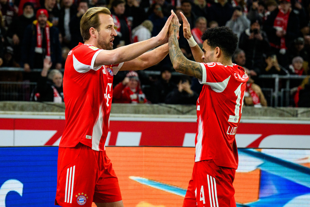 Munich's Harry Kane, left, celebrates with his teammate Luis Diaz, right, after scoring his side's second goal during the German Bundesliga soccer match between VfB Stuttgart and FC Bayern Munich in Stuttgart, Germany, Saturday, Dec. 6, 2025. (Tom Weller/dpa via AP)