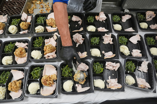 A volunteer prepares meals at the Philabundance Community Kitchen in Philadelphia, Thursday, Oct. 30, 2025. (AP Photo/Matt Rourke) A volunteer prepares meals at the Philabundance Community Kitchen in Philadelphia, Thursday, Oct. 30, 2025. (AP Photo/Matt Rourke)