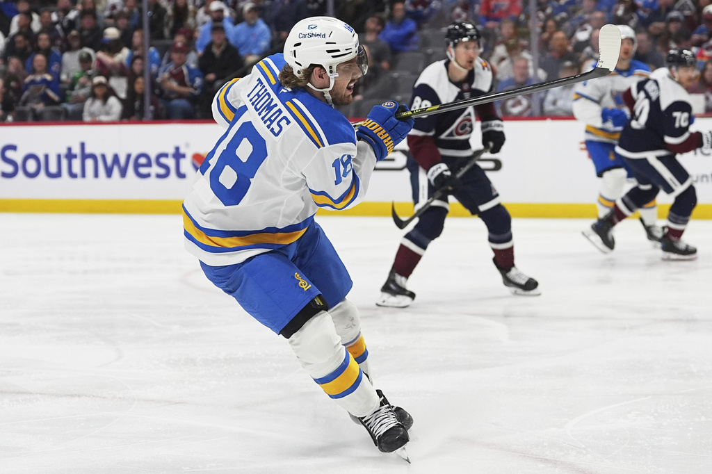 St. Louis Blues center Robert Thomas scores a goal against the Colorado Avalanche in the second period of an NHL hockey game Sunday, April 5, 2026, in Denver. (AP Photo/David Zalubowski)