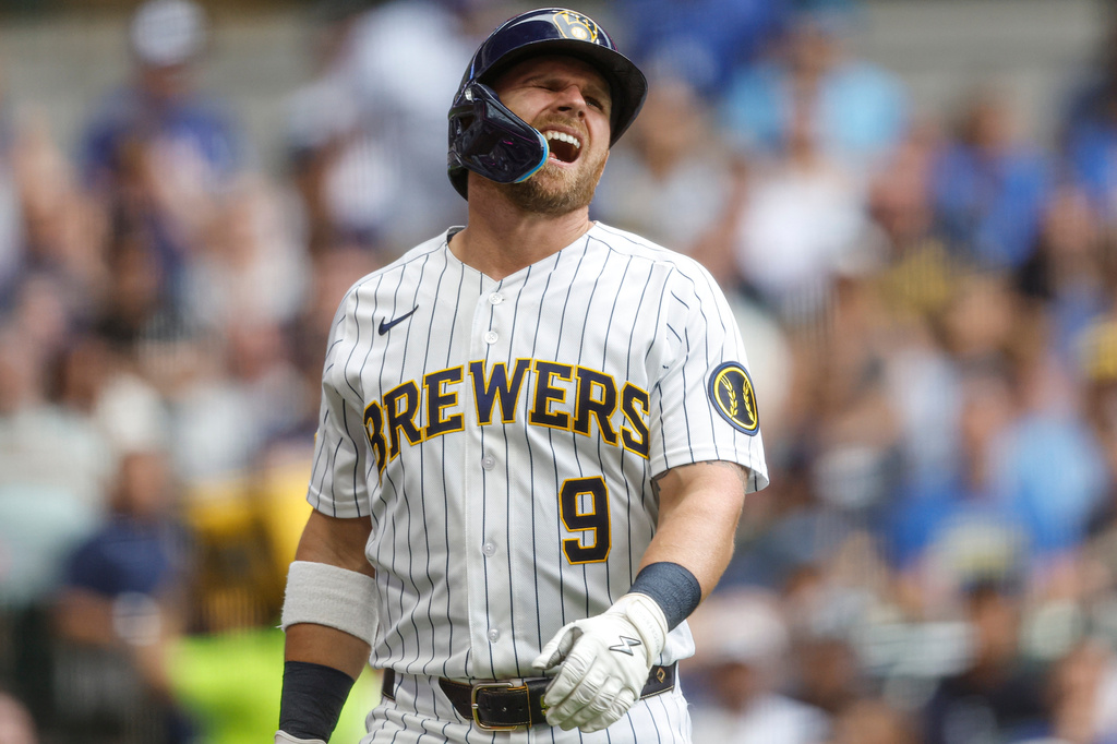 Milwaukee Brewers' Jake Bauers reacts after being hit by a pitch from the Texas Rangers during the fifth inning of a baseball game Sunday, Aug. 30, 2026, in Milwaukee. (AP Photo/Jeffrey Phelps)