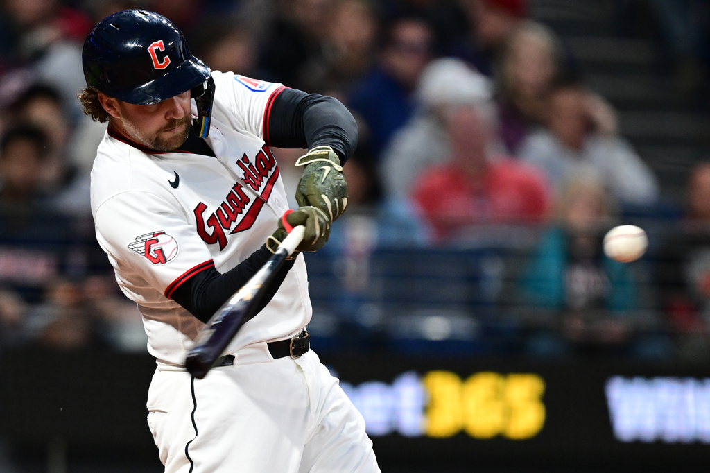 Cleveland Guardians' Rhys Hoskins hits a solo home run off Cincinnati Reds starting pitcher Andrew Abbott during the sixth inning of a baseball game, Friday, May 15, 2026, in Cleveland. (AP Photo/David Dermer)