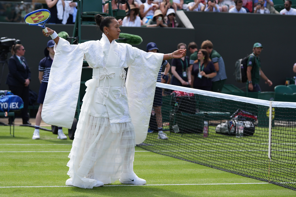 Naomi Osaka of Japan walks into the court to play against Elsa Jacquemot of France in their first round women's singles match at the Wimbledon Tennis Championships in London, Monday, June 29, 2026. (AP Photo/Maja Smiejkowska)