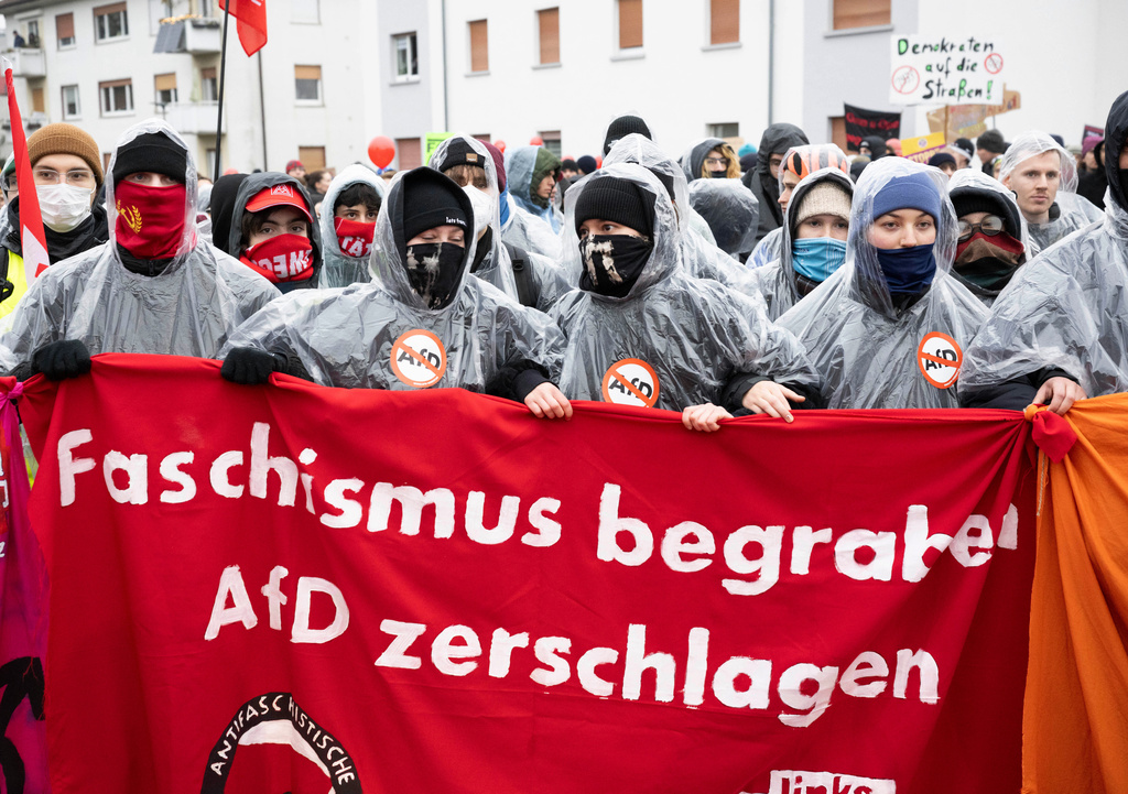 Demonstrators hold a banner that reads: "Bury Fascism - Smash the AfD", as thousands gather in Giessen, Germany, Saturday Nov. 29, 2025, as the far-right Alternative for Germany’s new youth organization is set to kick off its founding convention. (Boris Roessler/dpa via AP)