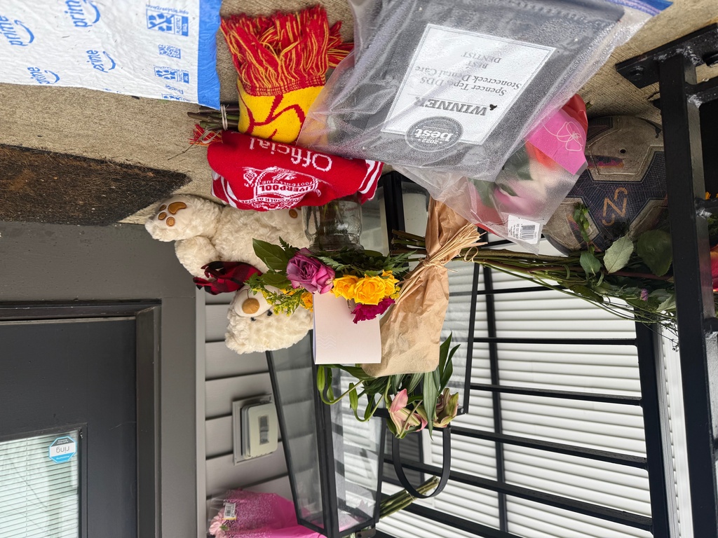 Flowers and other items sit on the front porch of Spencer and Monique Tepe's home in Columbus, Ohio, on Tuesday, Jan. 6, 2026. (AP Photo/Patrick Aftoora-Orsagos)