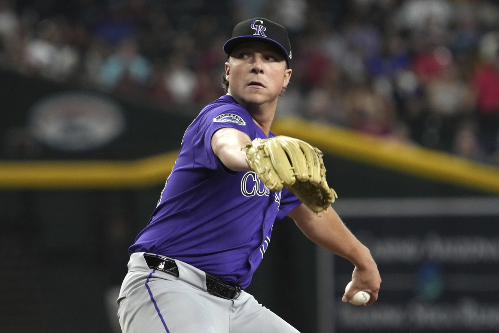 Colorado Rockies pitcher Ryan Rolison throws against the Arizona Diamondbacks in the fifth inning of a baseball game, Sunday, Aug 10, 2025, in Phoenix. (AP Photo/Rick Scuteri)