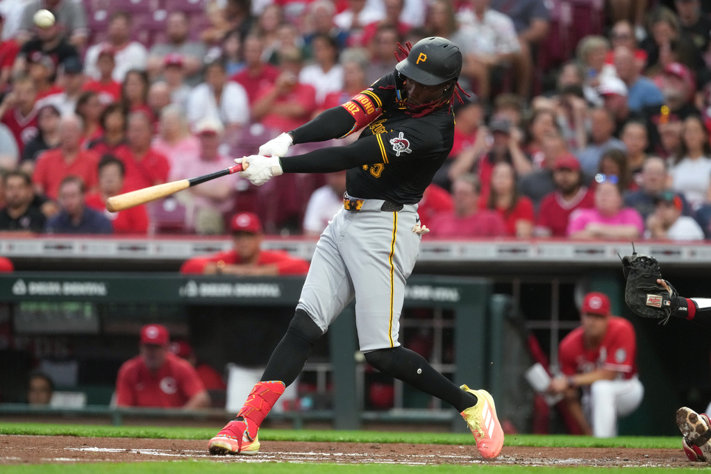 Pittsburgh Pirates' Oneil Cruz hits a two-run home run in the second inning of a baseball game against the Cincinnati Reds, Tuesday, Sept. 23, 2025, in Cincinnati. (AP Photo/Kareem Elgazzar)