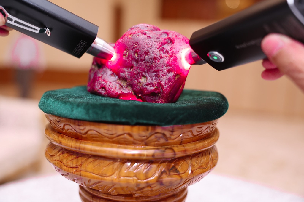 In this photo provided by Myanmar Military True News Information Team on Thursday, May 7, 2026, Myanmar officials inspect a newly discovered ruby at the president office in Naypyitaw, Myanmar. (Myanmar Military True News Information Team via AP Photo)