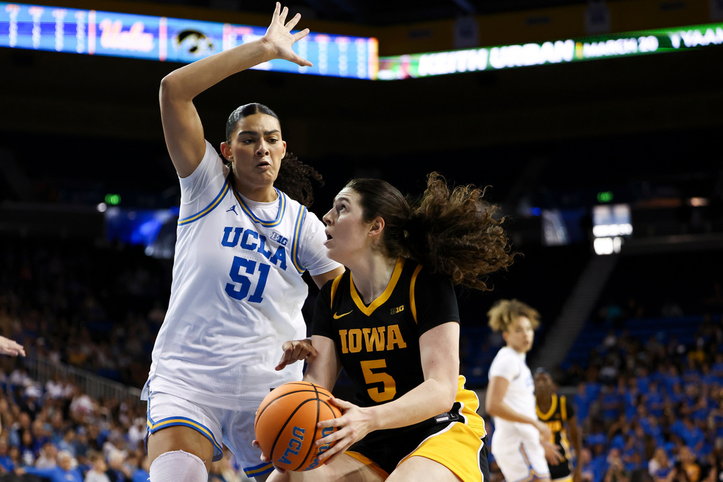 Iowa center Ava Heiden (5) drives against UCLA center Lauren Betts (51) during the first half of an NCAA college basketball game, Sunday, Feb. 1, 2026, in Los Angeles. (AP Photo/Jessie Alcheh)