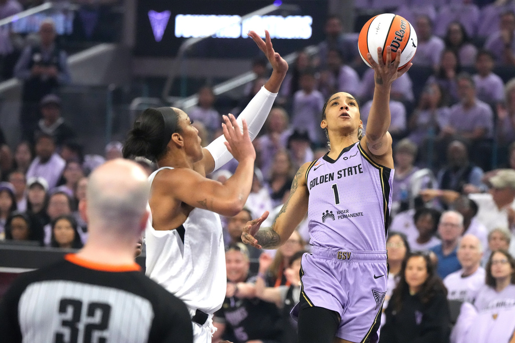 Golden State Valkyries forward Gabby Williams (1) drives to the basket against Las Vegas Aces center A'ja Wilson, second from right, during the first half of Game 1 of the WNBA basketball semifinals in San Francisco, Sunday, Oct. 4, 2026. (AP Photo/Tony Avelar)