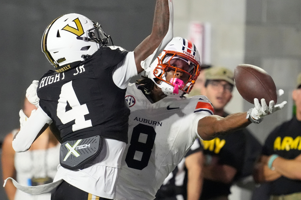 FILE - Auburn wide receiver Cam Coleman (8) catches a touchdown pass in the end zone past Vanderbilt cornerback Martel Hight (4) during the second half of an NCAA college football game, Nov. 8, 2025, in Nashville, Tenn. (AP Photo/George Walker IV, File)