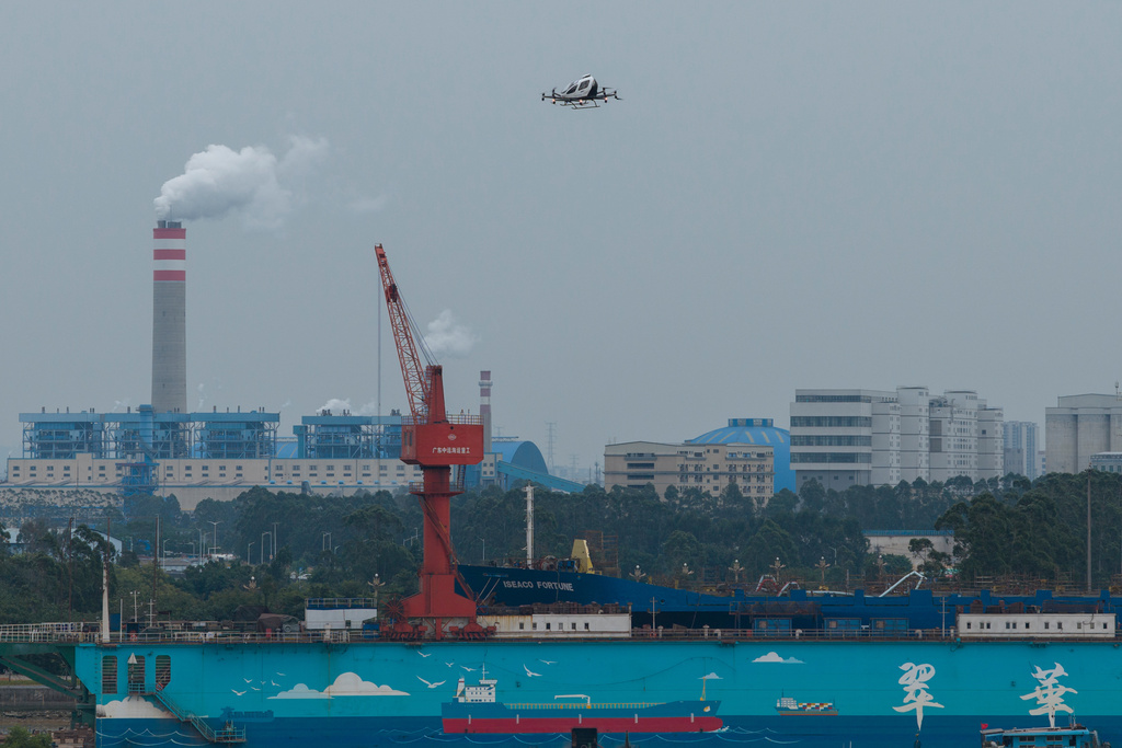 The EHang eVTOL EH126-S takes to the sky over a port in Guangzhou in southern China's Guangdong province on Monday, Nov. 3, 2025. (AP Photo/Ng Han Guan)