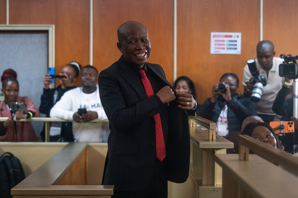 Julius Malema, Economic Freedom Fighters (EFF) party leader, shares a light moment with journalists inside a courtroom, after he was sentenced to prison for firing a rifle at a political rally, in East London, South Africa, Thursday, April 16, 2026. (AP Photo)