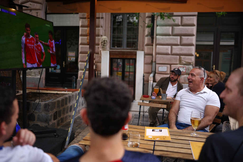 FILE - Fans watch the Champions League final soccer match between Paris Saint-Germain and Arsenal in Budapest, Hungary, May 30, 2026. (AP Photo/Rudolf Karancsi-Albert, File)