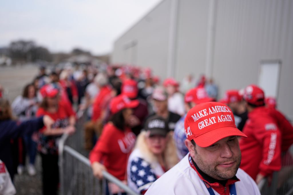 People wait to enter to see President Donald Trump speak at a rally at Coosa Steel Corporation in Rome, Ga., Thursday, Feb. 19, 2026. (AP Photo/George Walker IV)