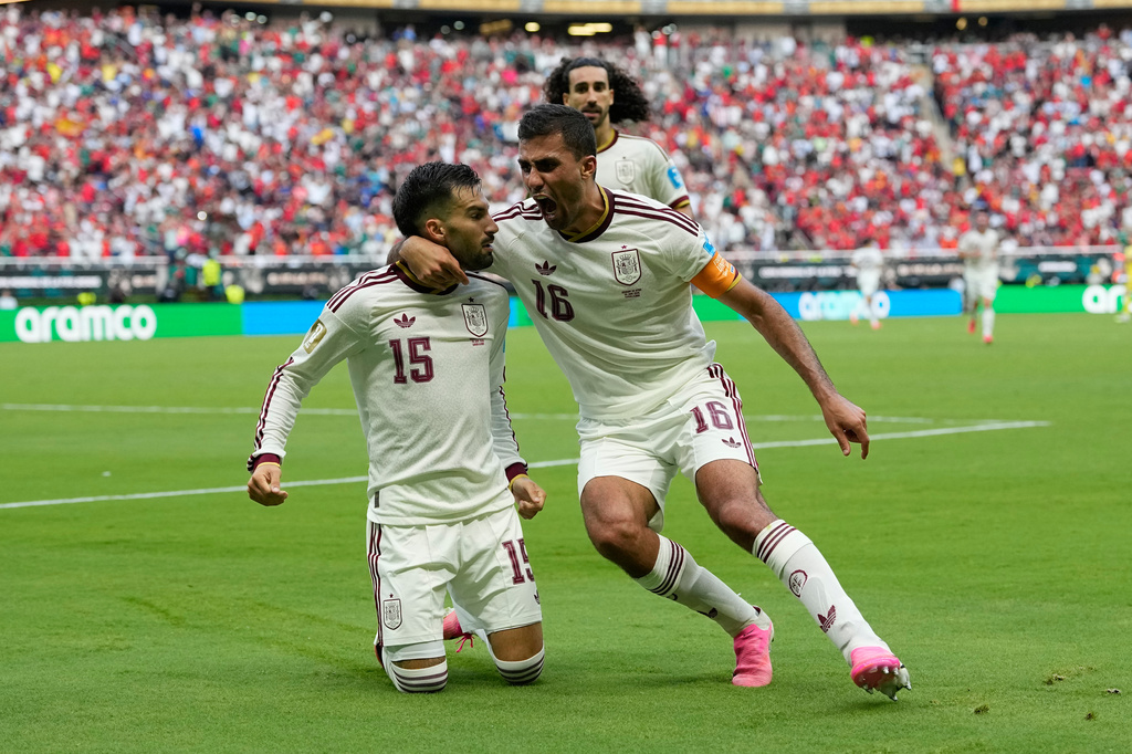 Spain's Alex Baena, left, is congratulated after scoring his side's opening goal by Rodri during the World Cup Group H soccer match between Uruguay and Spain in Zapopan, near Guadalajara, Mexico, Friday, June 26, 2026. (AP Photo/Natacha Pisarenko)
