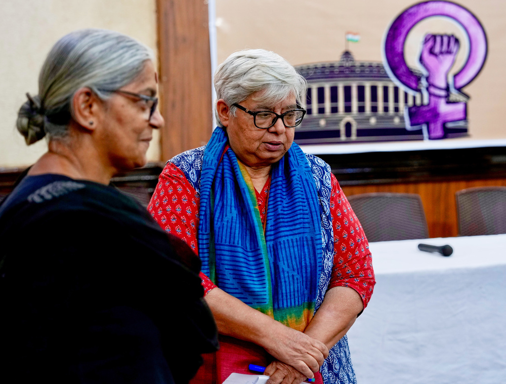 Communist Party of India member Annie Raja, left, and activist Shabnam Hashmi have a chat before a press conference on sending a petition on women's reservation to the parliamentarians in New Delhi, India, Thursday, April 16, 2026. (AP Photo/Manish Swarup)