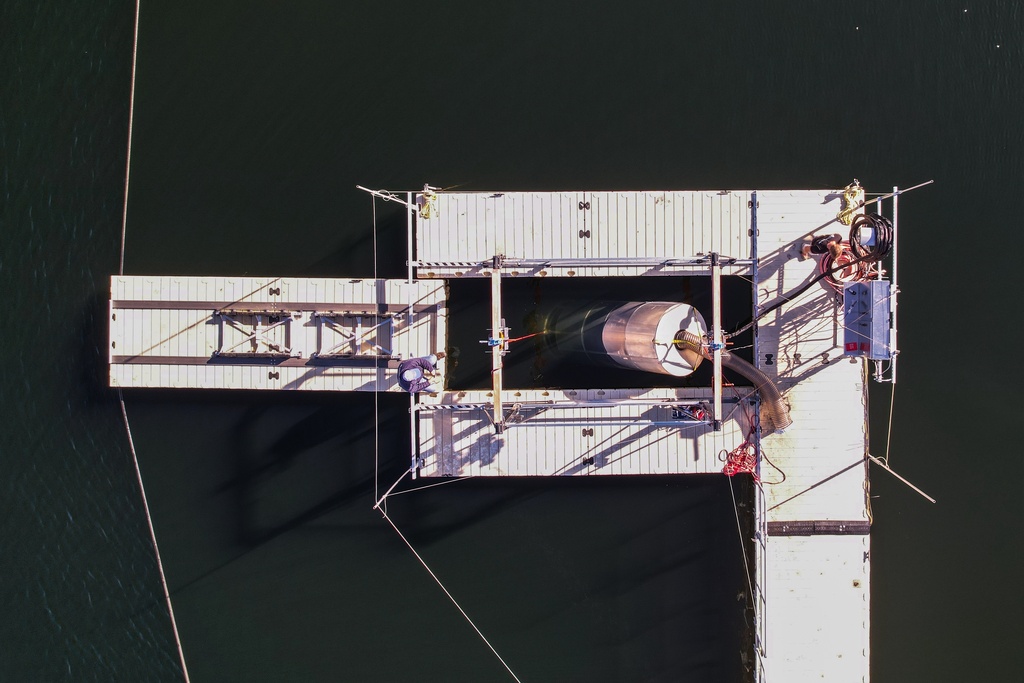 A prototype OceanWell reverse osmosis pod is lowered into Las Virgenes Reservoir in Westlake Village, Calif., Monday, Dec. 1, 2025, where the deep sea desalination technology is being tested. (AP Photo/Annika Hammerschlag)