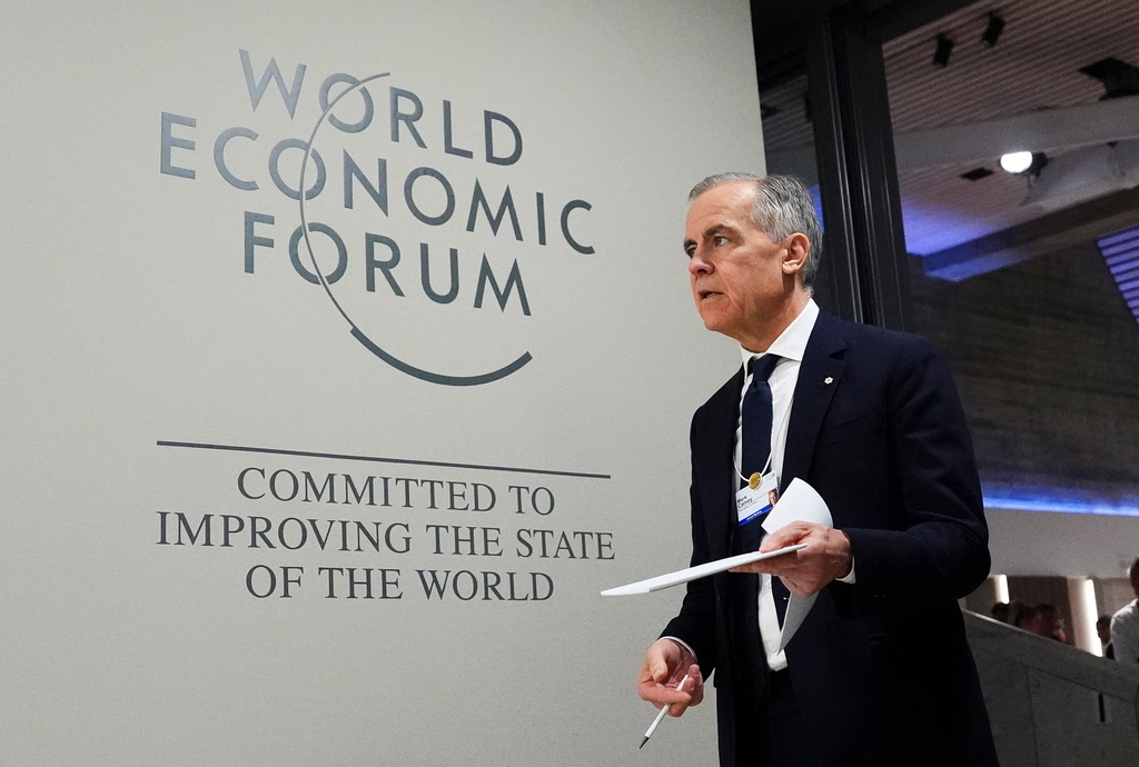 Canada Prime Minister Mark Carney makes his way to take part in an event tilted "Country Strategy Dialogue: Canada" as he attends the World Economic Forum in Davos, Switzerland on Tuesday, Jan. 20, 2026. (Sean Kilpatrick/The Canadian Press via AP)