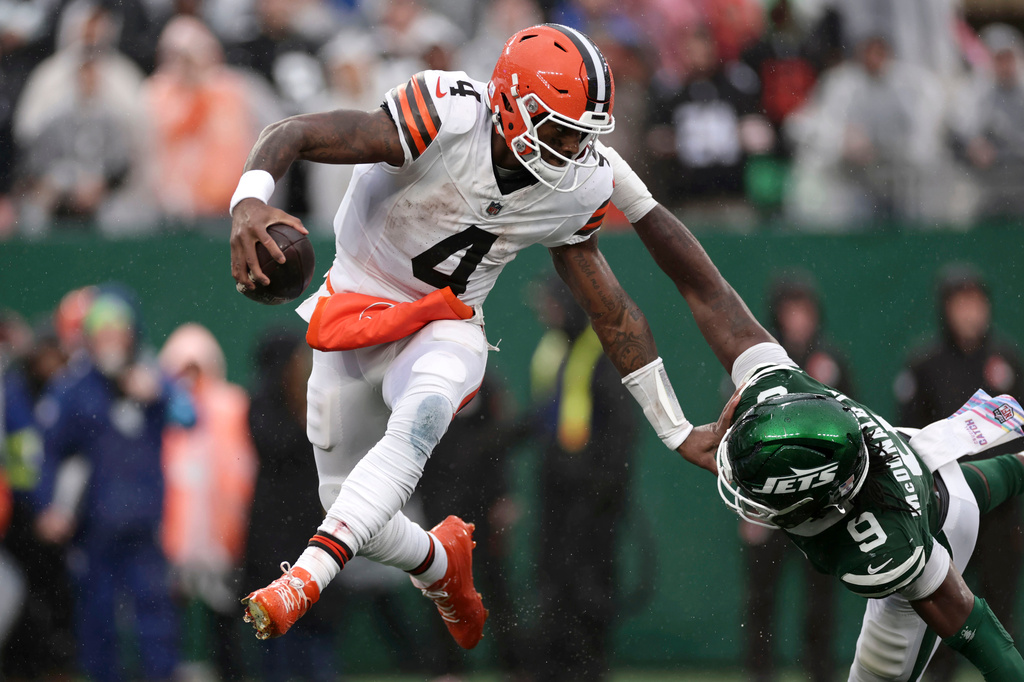 Cleveland Browns quarterback Deshaun Watson (4) runs from New York Jets defensive end Will McDonald IV (9) during the second half of an NFL football game, Sunday, Oct. 11, 2026, in East Rutherford, N.J. (AP Photo/Adam Hunger)