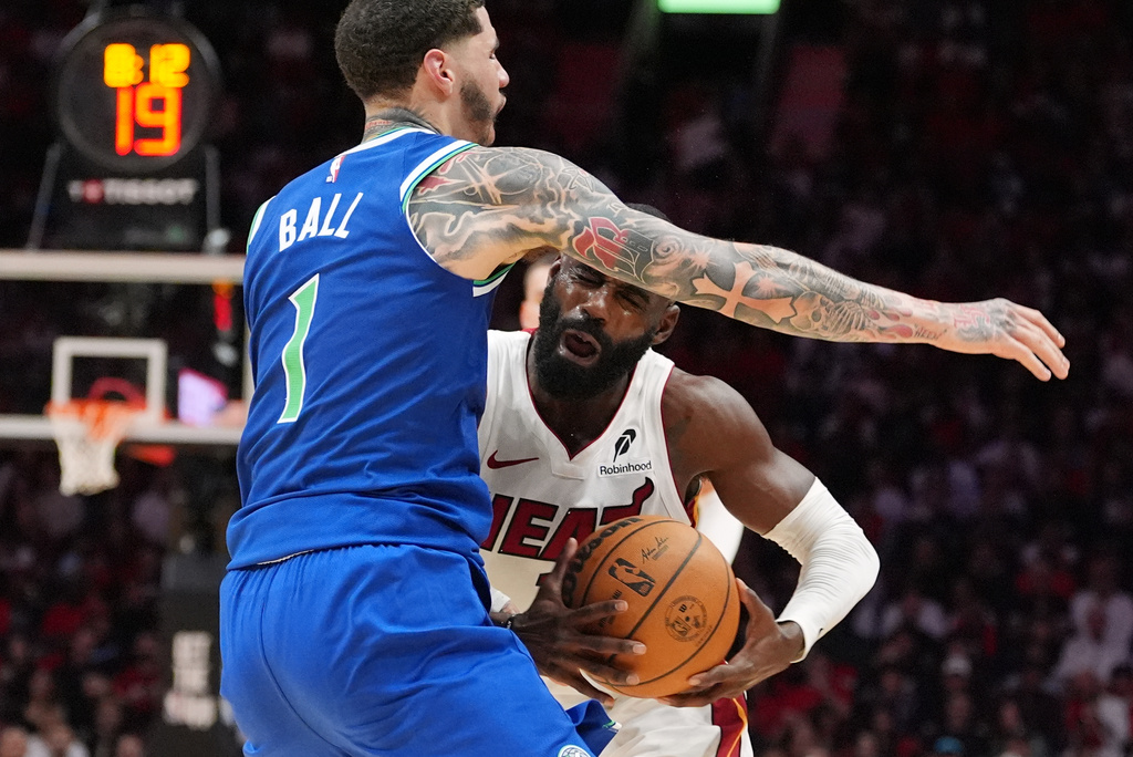 Miami Heat guard Tim Hardaway Jr. (10) clashes with Minnesota Timberwolves guard LaMelo Ball (1) during the first half of an NBA basketball game, Wednesday, Oct. 21, 2026, in Miami. (AP Photo/Rebecca Blackwell)