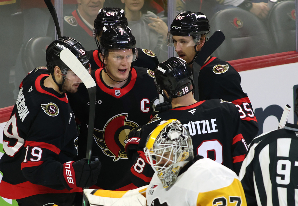 Ottawa Senators' Brady Tkachuk, center, celebrates his goal with teammates during the first period of an NHL hockey game against the Pittsburgh Penguins in Ottawa, Ontario, Thursday, Dec. 18, 2025. (Patrick Doyle/The Canadian Press via AP)