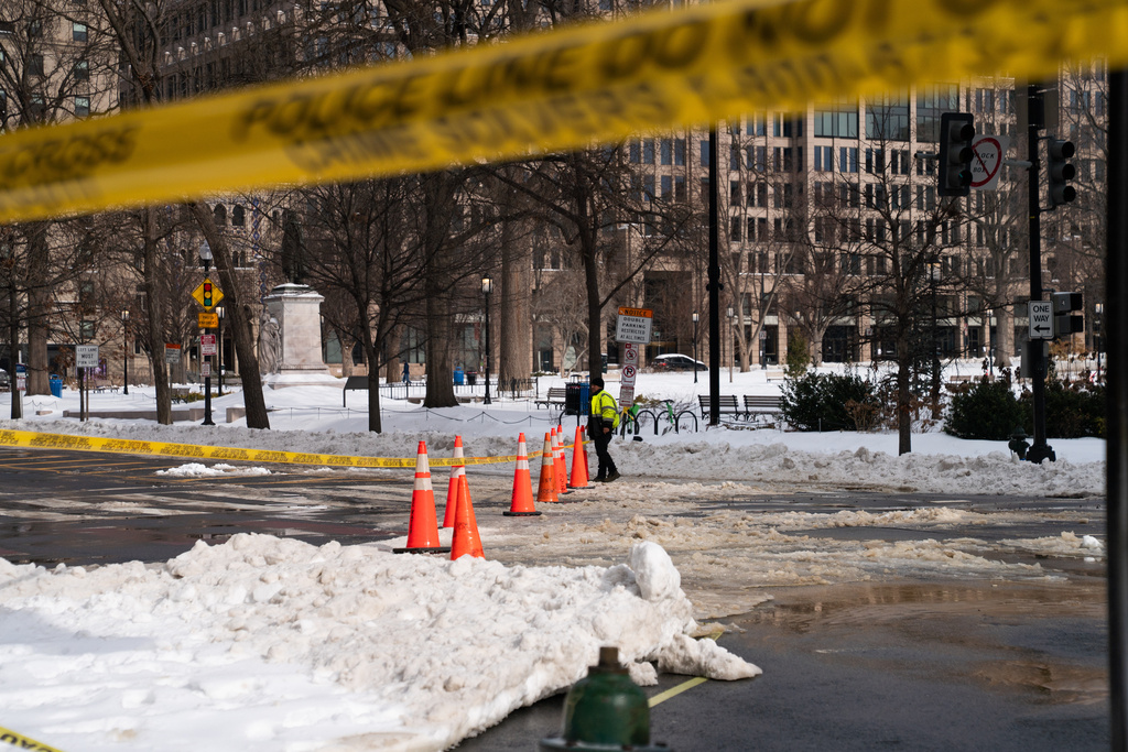 DC Water crews work around snow piles to repair a water main break, Monday, Jan. 26, 2026, in Washington. (AP Photo/Allison Robbert)