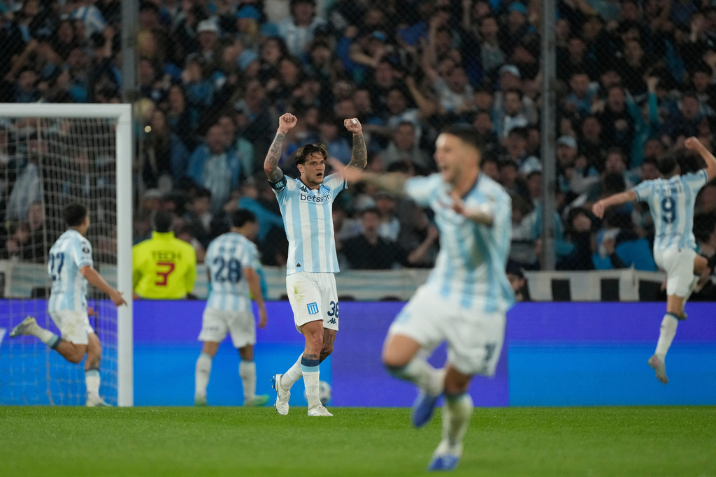 Bruno Zuculini of Argentina's Racing Club, center, celebrates after teammate Santiago Solari scored his side's opening goal against Argentina's Velez Sarsfield during a Copa Libertadores quarterfinal second leg soccer match at Presidente Peron stadium in Avellaneda, Argentina, Tuesday, Sept. 23, 2025. (AP Photo/Gustavo Garello)