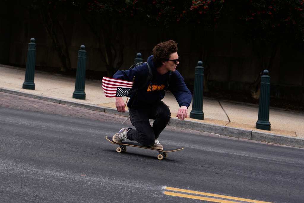 A man skateboards past the Rayburn House Office Building while holding an upside down American flag during the annual March for Life, Friday, Jan. 23, 2026, in Washington. (AP Photo/Julia Demaree Nikhinson)