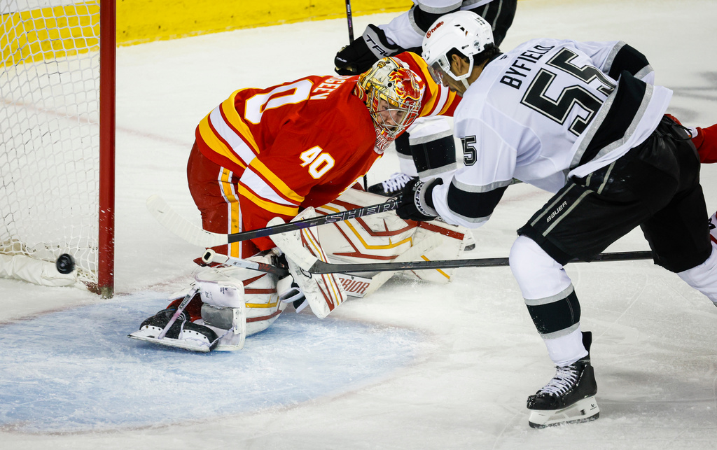 Los Angeles Kings' Quinton Byfield, right, scores against Calgary Flames goalie Arsenii Sergeev (40) during second-period NHL hockey game action in Calgary, Alberta, Thursday, April 16, 2026. (Jeff McIntosh/The Canadian Press via AP)
