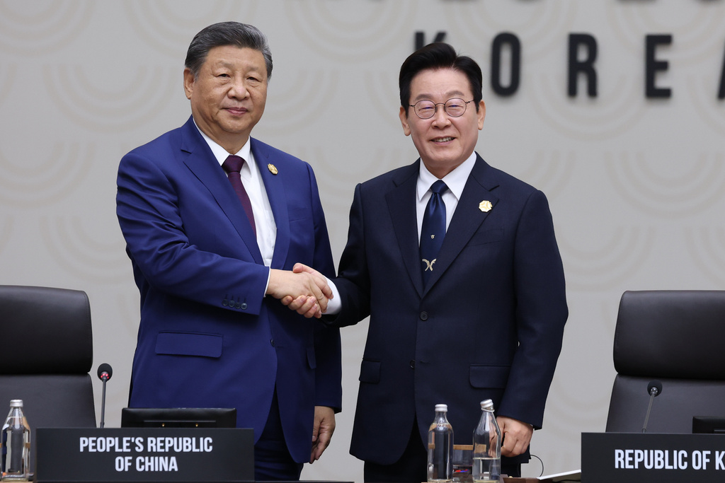 Chinese President Xi Jinping shakes hands with South Korean President Lee Jae Myung, at the Asia-Pacific Economic Cooperation (APEC) Economic Leaders' Meeting in Gyeongju, South Korea, Saturday, Nov. 1, 2025. (Yonhap via AP)