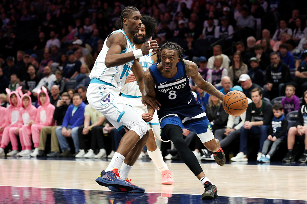 Minnesota Timberwolves guard Bones Hyland, right, works around Charlotte Hornets forward Moussa Diabate (14) during the first half of an NBA basketball game, Sunday, April 5, 2026, in Minneapolis. (AP Photo/Matt Krohn)