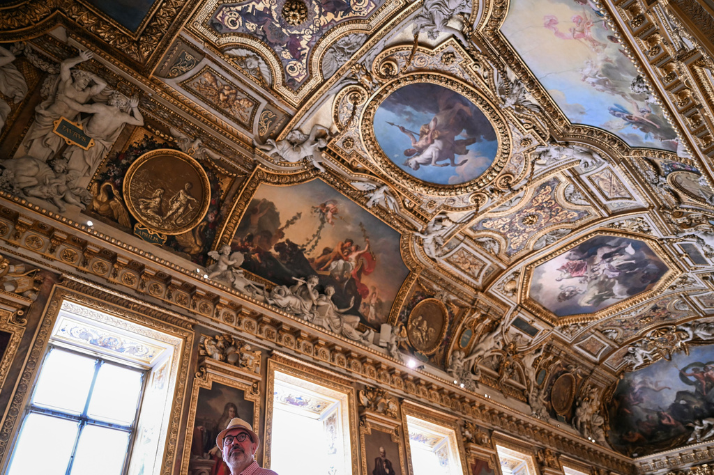 A visitor looks on during the reopening to the public of the Apollo Gallery, at the Louvre museum in Paris, Wednesday, July 22, 2026. (Lou Benoist/Pool Photo via AP)