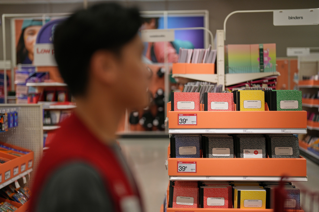 An employee passes the back-to-school section at a Target store, Thursday, Aug. 13, 2026, in Woodbury, Minn. (AP Photo/Ellen Schmidt)